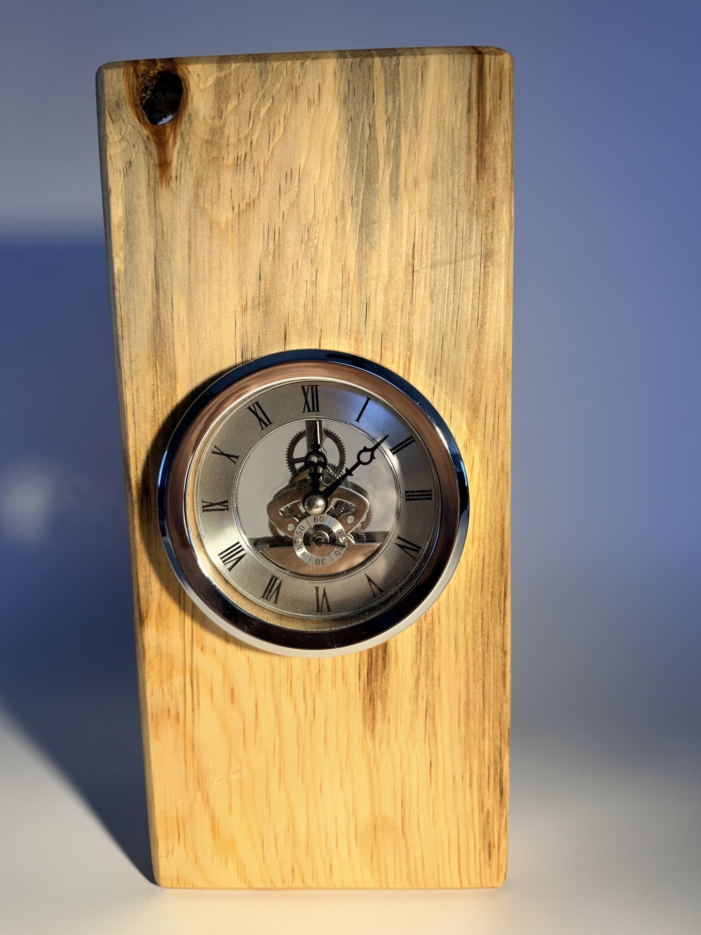 Timeless cottonwood desk clock with visible skeleton gears, front view