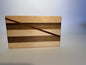 Short Cuts walnut and maple cutting board with diagonal padauk stripe, front view