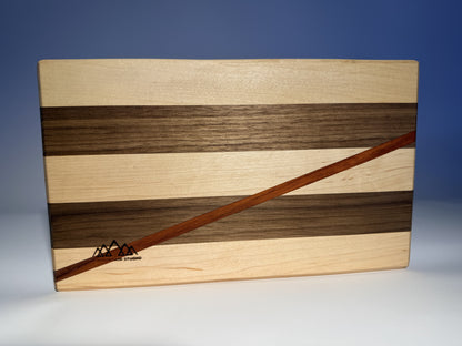 Close-up of padauk stripe and branded JMMS logo on Short Cuts board