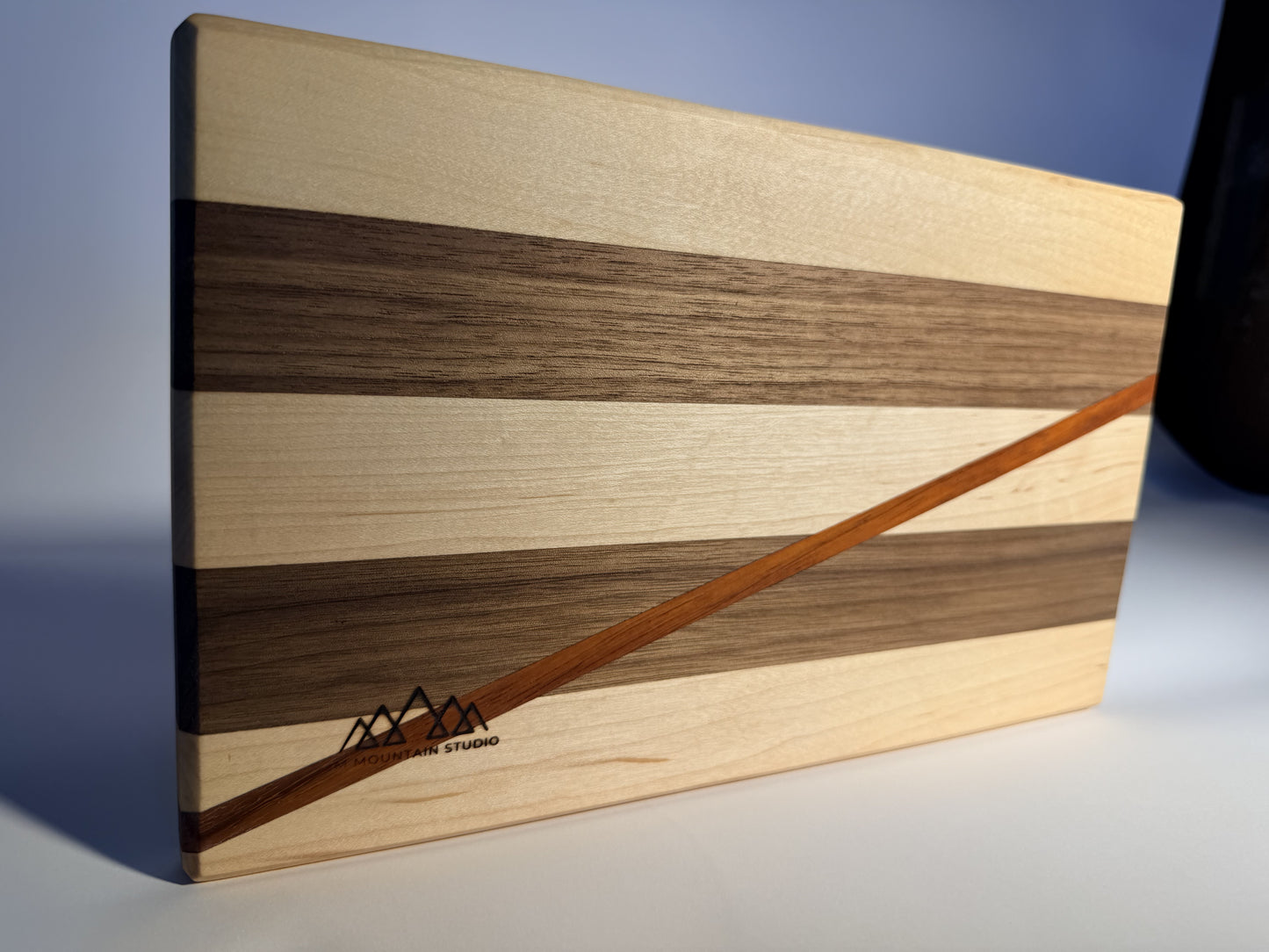 Short Cuts cutting board angled view with JMMS Mountain Studio brand