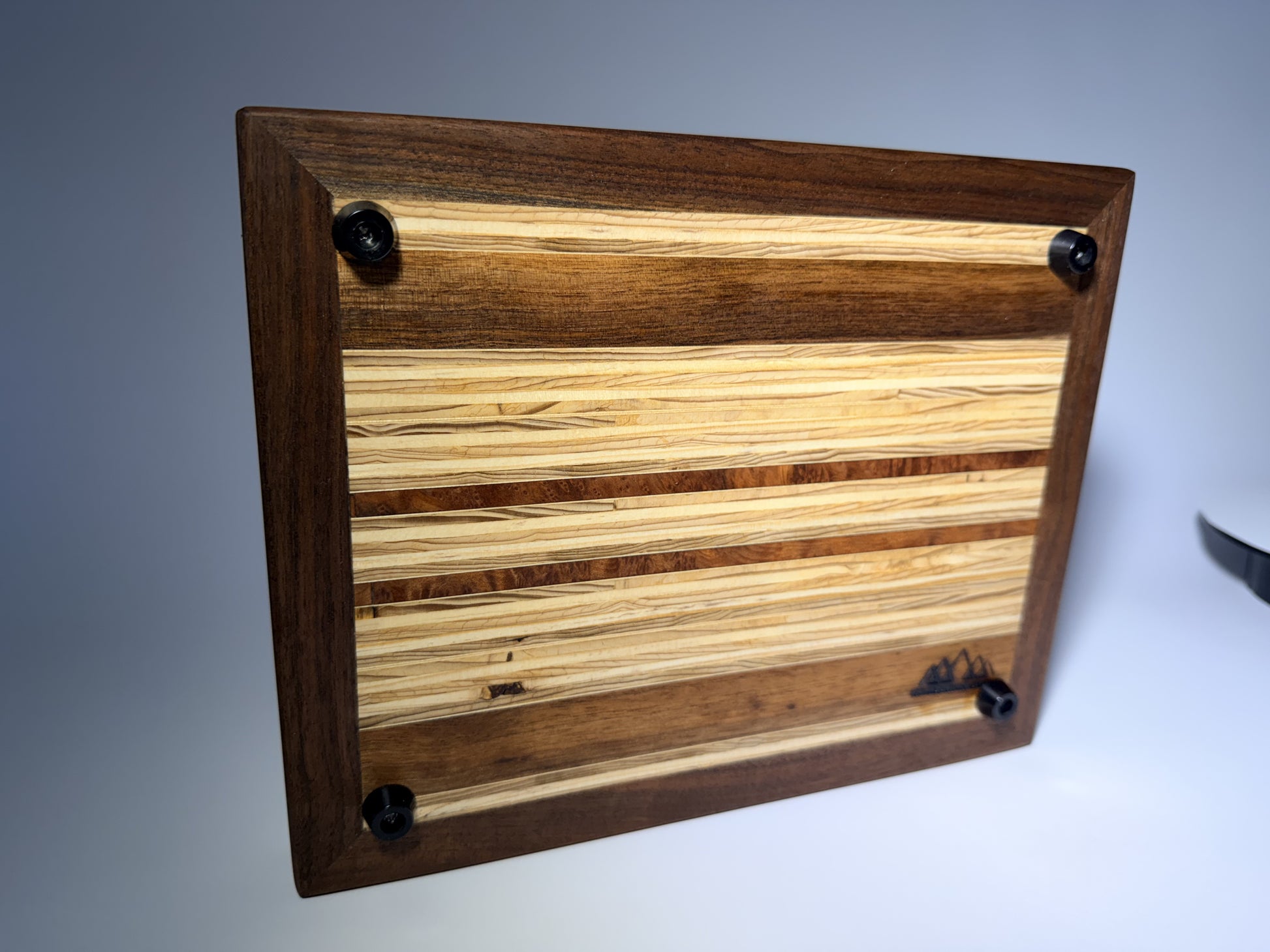 Walnut-framed cutting board — angled back view with feet