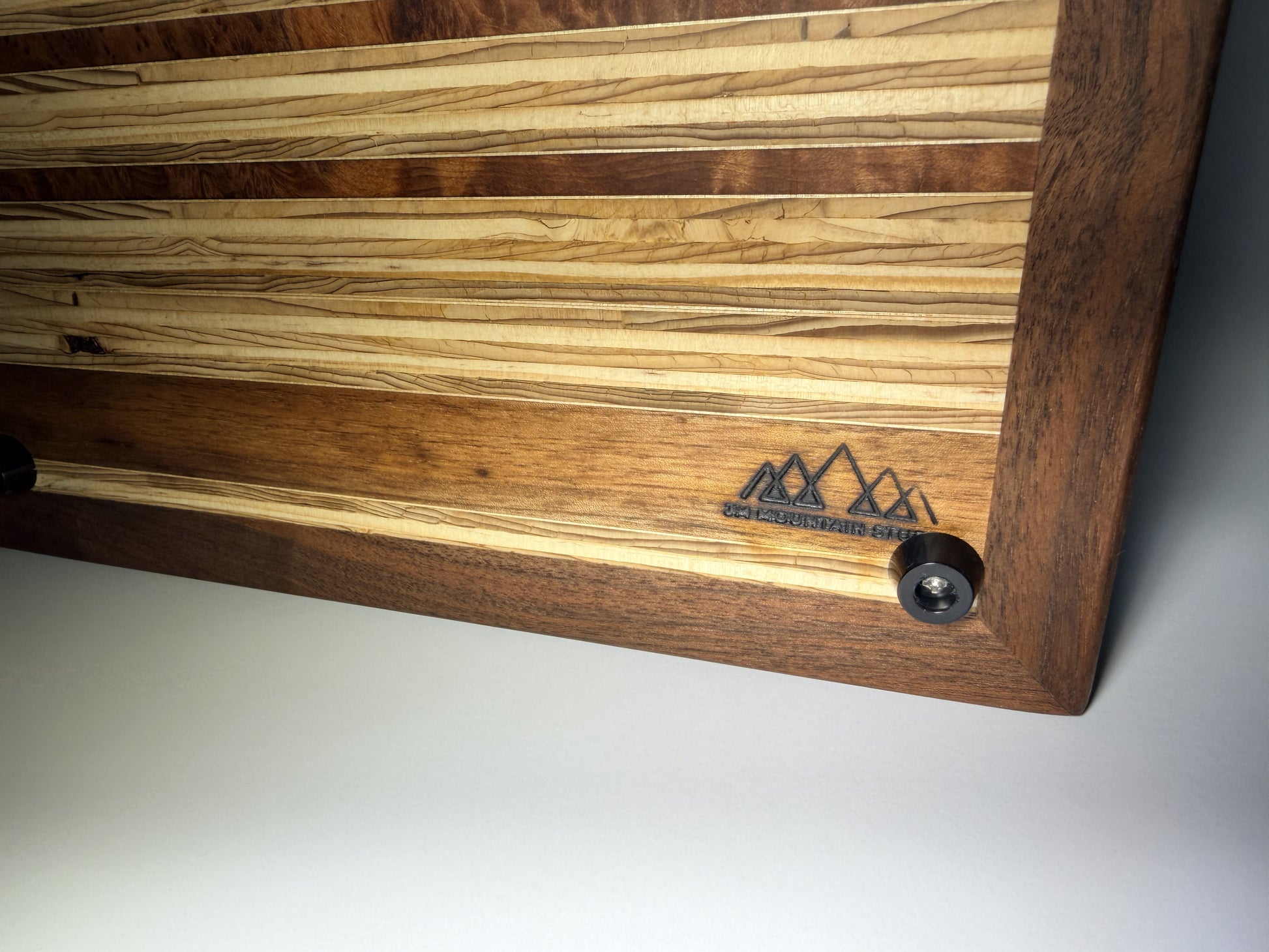 Walnut frame and striped grain with branded logo — close-up