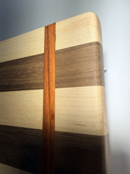 Walnut, maple, and padauk grain — edge close-up