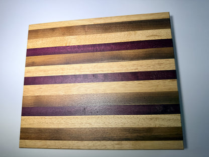 Striped cutting board with purpleheart and walnut — full face view