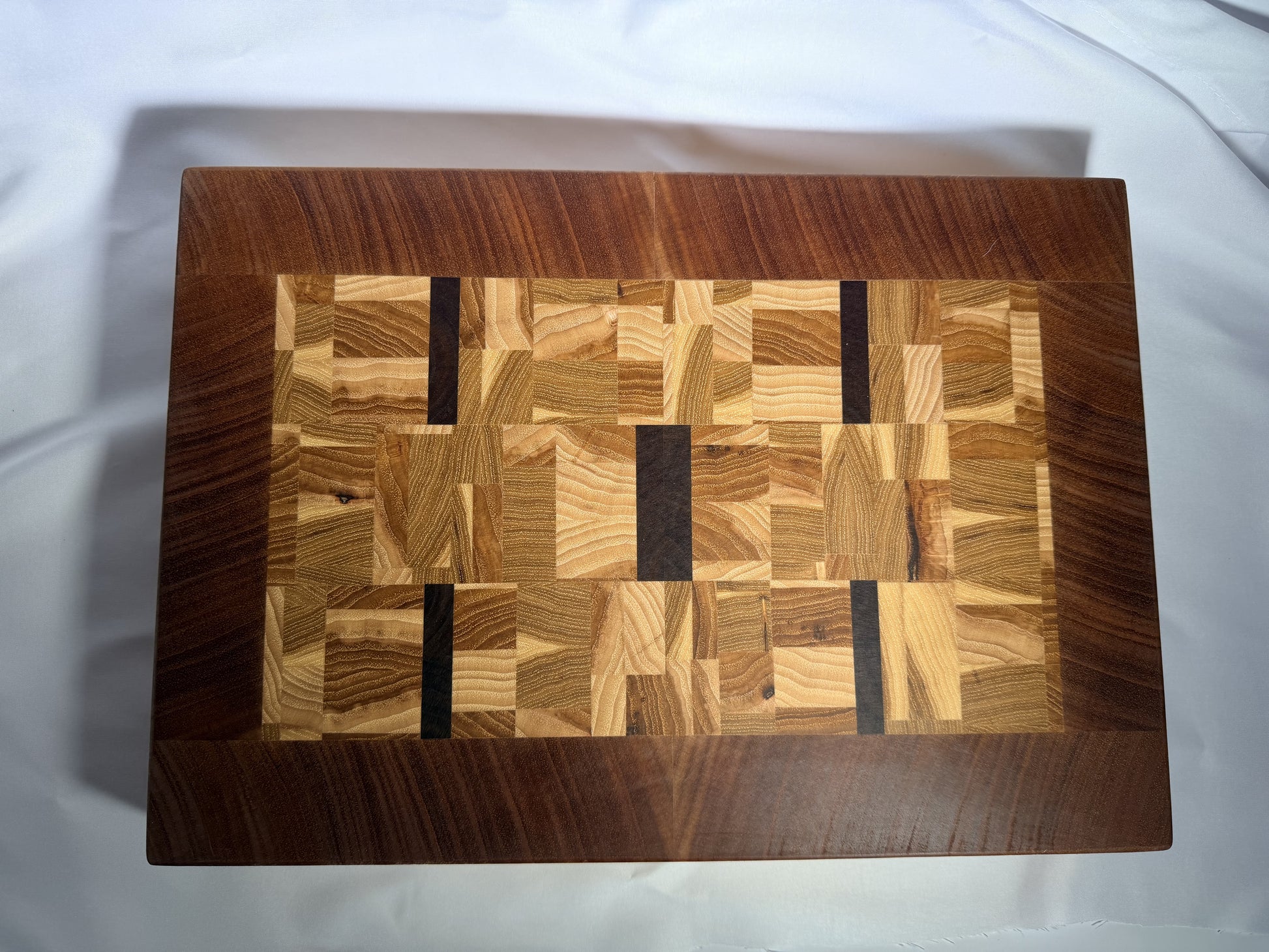 End-grain mosaic cutting board with mahogany border — full face view