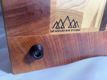 JM Mountain Studio branded logo on mahogany — close-up