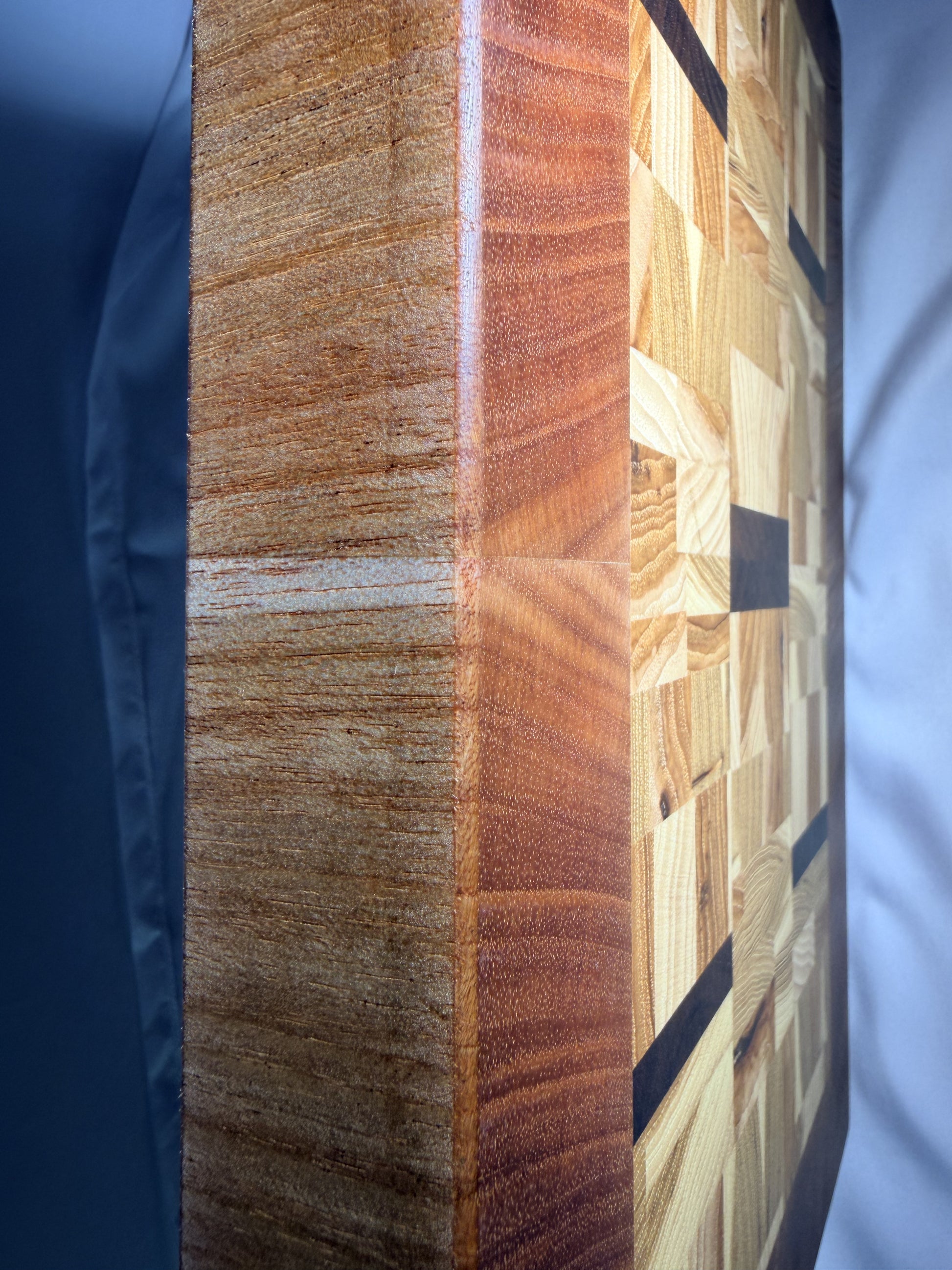 End-grain mosaic cutting board — edge profile close-up