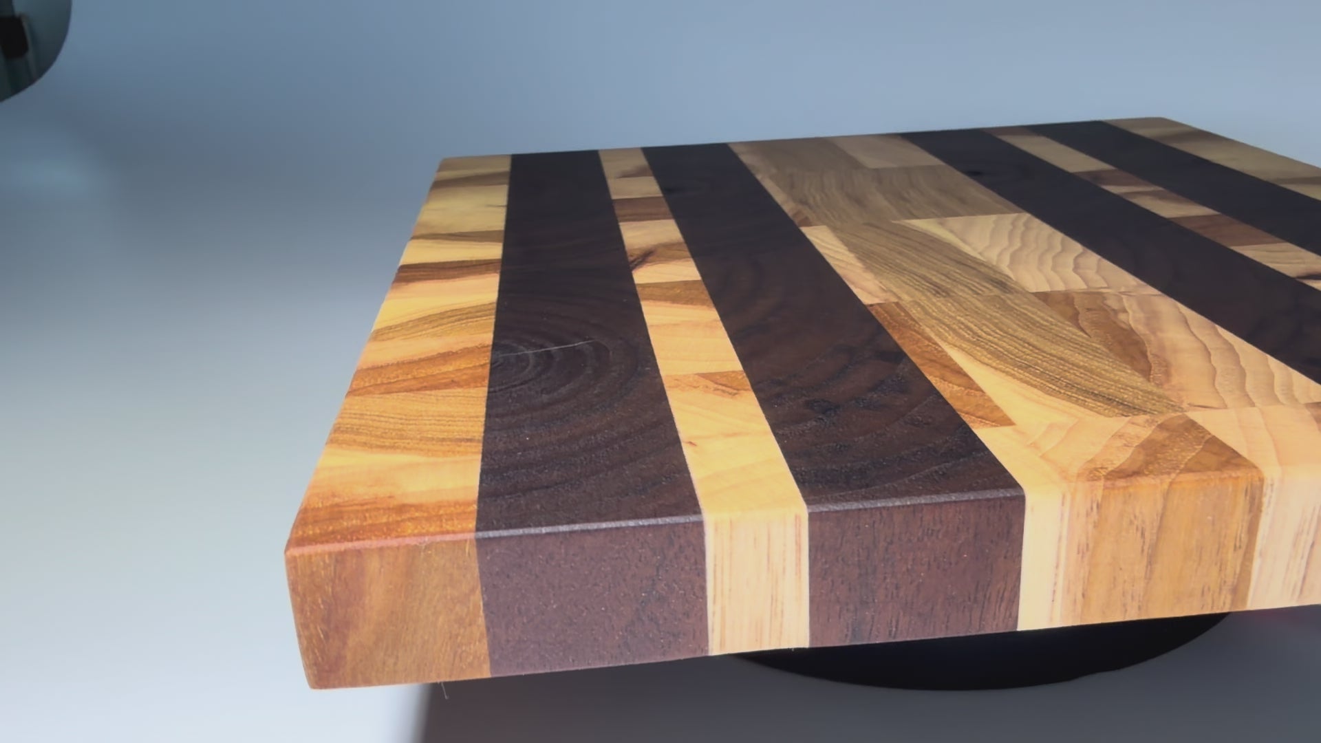 End-grain walnut and oak striped board — rotating flat view