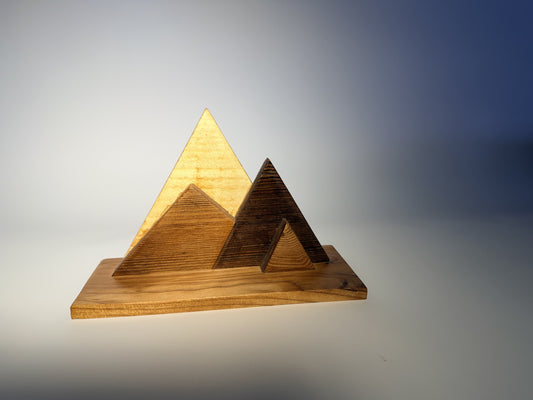 Mountain Ridgeline sculpture in reclaimed pine and cedar, three-quarter hero view with light raking across the peaks